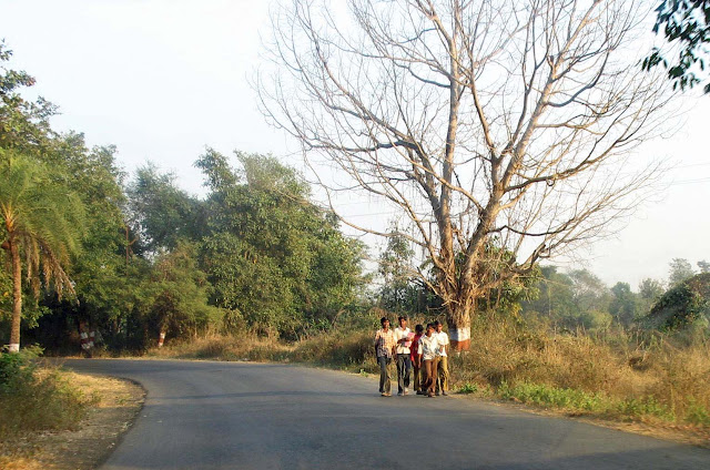 boys walking with books in rural india