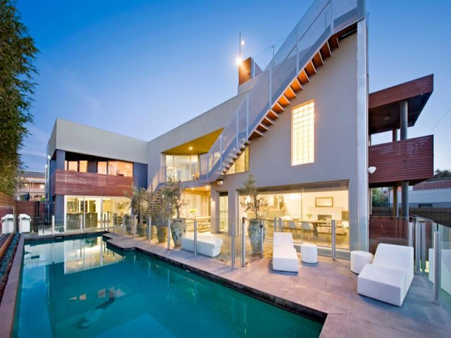 Photo of modern home as seen from the pool area in the backyard