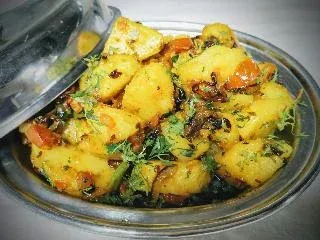 Cubes of aloo in a bowl tempered with cumin jeera aloo vegan food