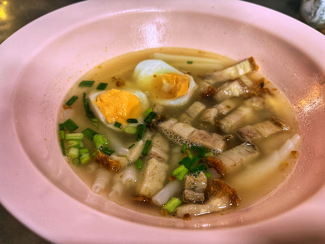 kuay jap with crispy pork belly and a boiled egg