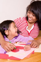 montessori teacher young girl make valentine's day card activities in the classroom