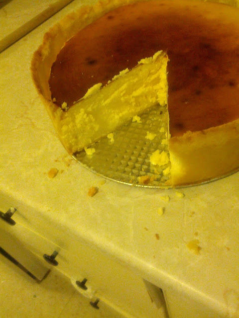 a cheesecake on a kitchen counter with a slice cut out