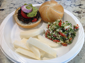 vegetarian burger, jicama slices, and tabbouleh salad on a plate