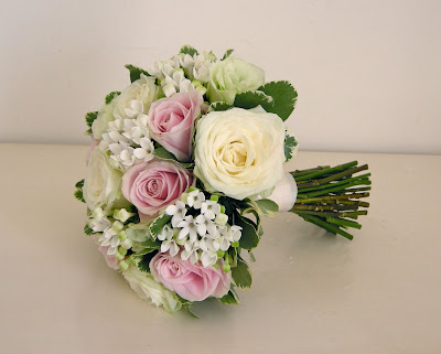 Classic bridal bouquet of ivory and pink roses green lisianthusbouvardia