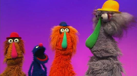 Sesame Street Episode 4516. Grover plays a game with his friends Sally, Phil and Bill. The monsters wear different colored hats, and Grover asks which monster is the tallest.