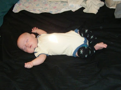 Spencer napping in our bed with skull baby legs