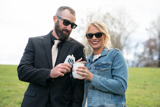Bride and Groom cheering their bud light and travel flute with sunglasses on Magnolia Farm Asheville Wedding Photography captured by Houghton Photography