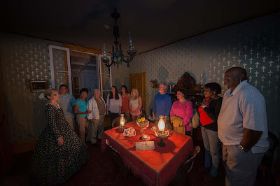 Image of People on Whaley House Tour grouped around a table