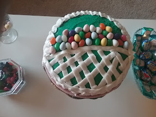 Cake decorated as an Easter basket, with jellybeans and chocolate eggs.