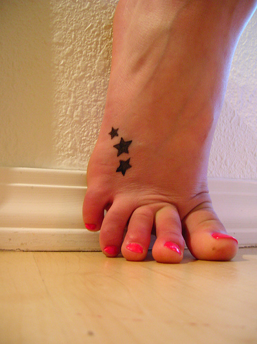 Flower and butterfly tattoos and flower designs on foot