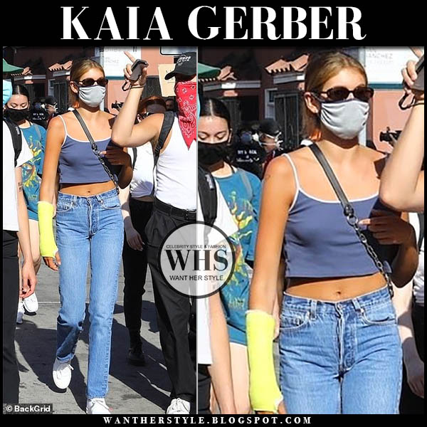 Kaia Gerber in blue cropped top, jeans and white sneakers