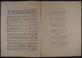 An open booklet. On the lefthand page is sheet music, and on the righthand verse. Both are titled "National Whig Song."