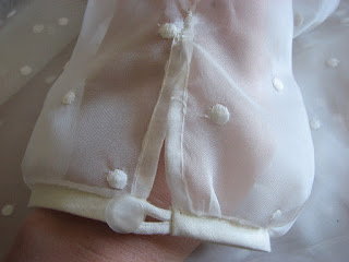 White sleeve cuff with a vintage button