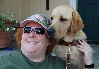 Laura Ann Grymes hugs her guide dog Dyson