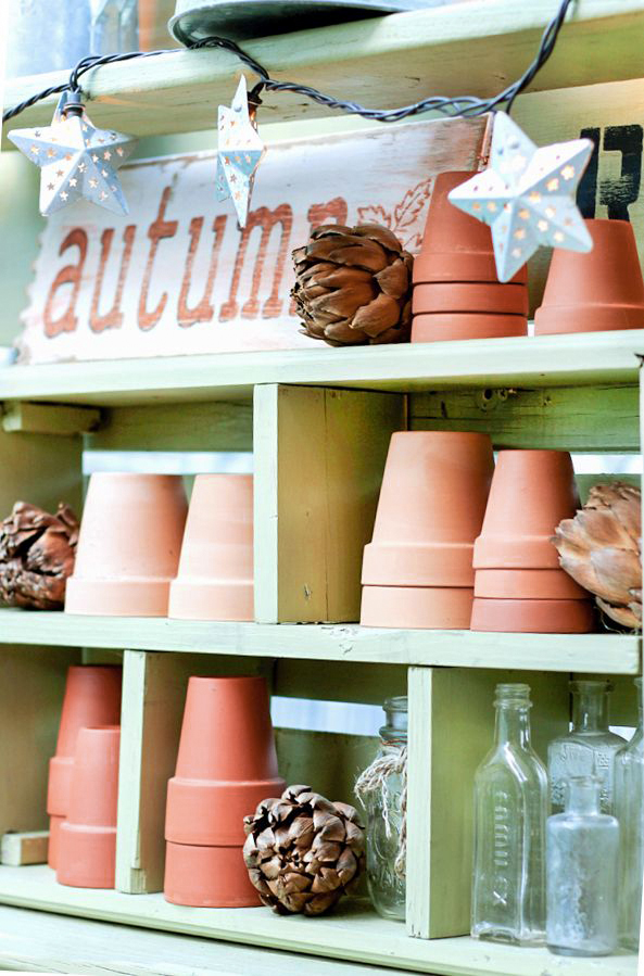 terracotta pots on potting bench - autumn sign