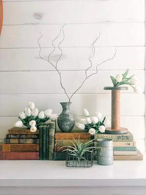 Styled table with vintage books and organic materials