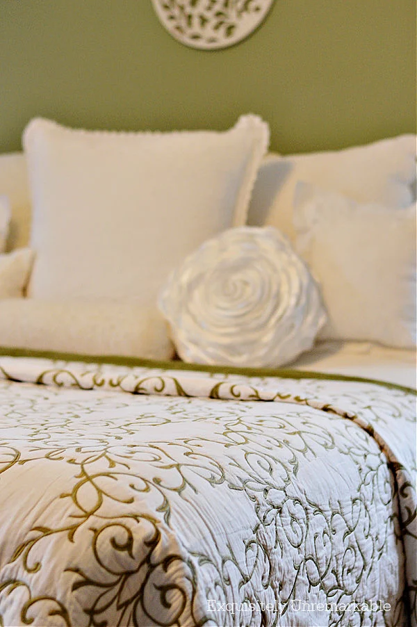 White And Green Scrolled Bedding with white pillows on bed