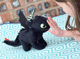 Girl stroking night fury dragon - toothless