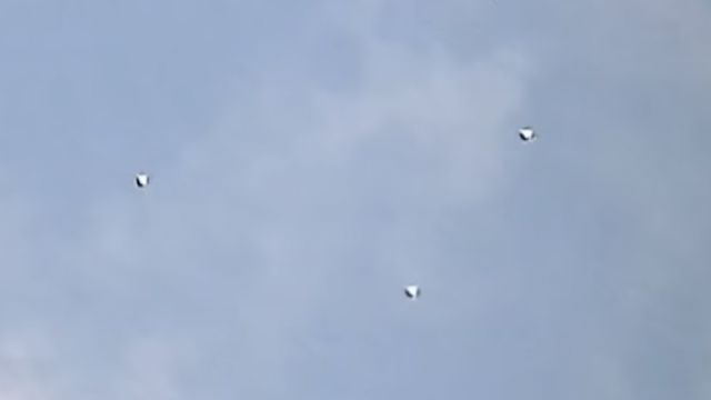 Three UFO Orbs that are being filmed over London in the UK during the day.