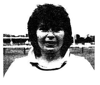 A black and white image of a smiling woman's face