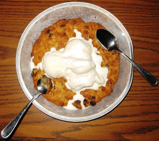 Pizookie Oatmeal Raisin cookie with icecream and two spoons