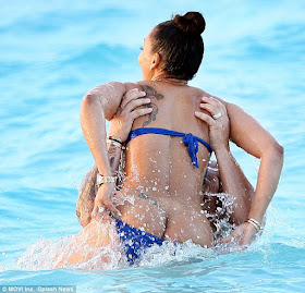 Sun's out, bum's out: Mel, 40, suffered an unfortunate wardrobe malfunction as she fooled around in the sea with Stephen Belafonte.