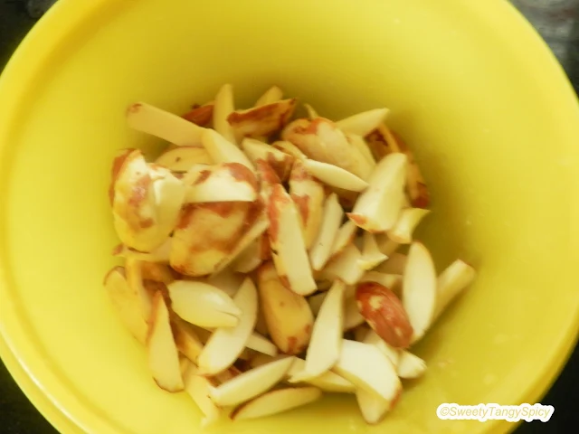 Freshly peeled jackfruit seeds being chopped into six equal parts.