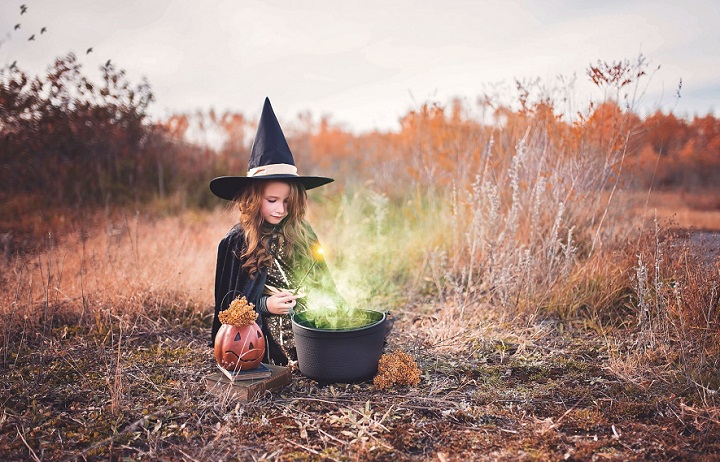 girl making witches potions in a field
