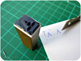 Close-up of letter 'A' with stamping examples.