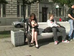 Teen flasher opens coat while sitting on a bench