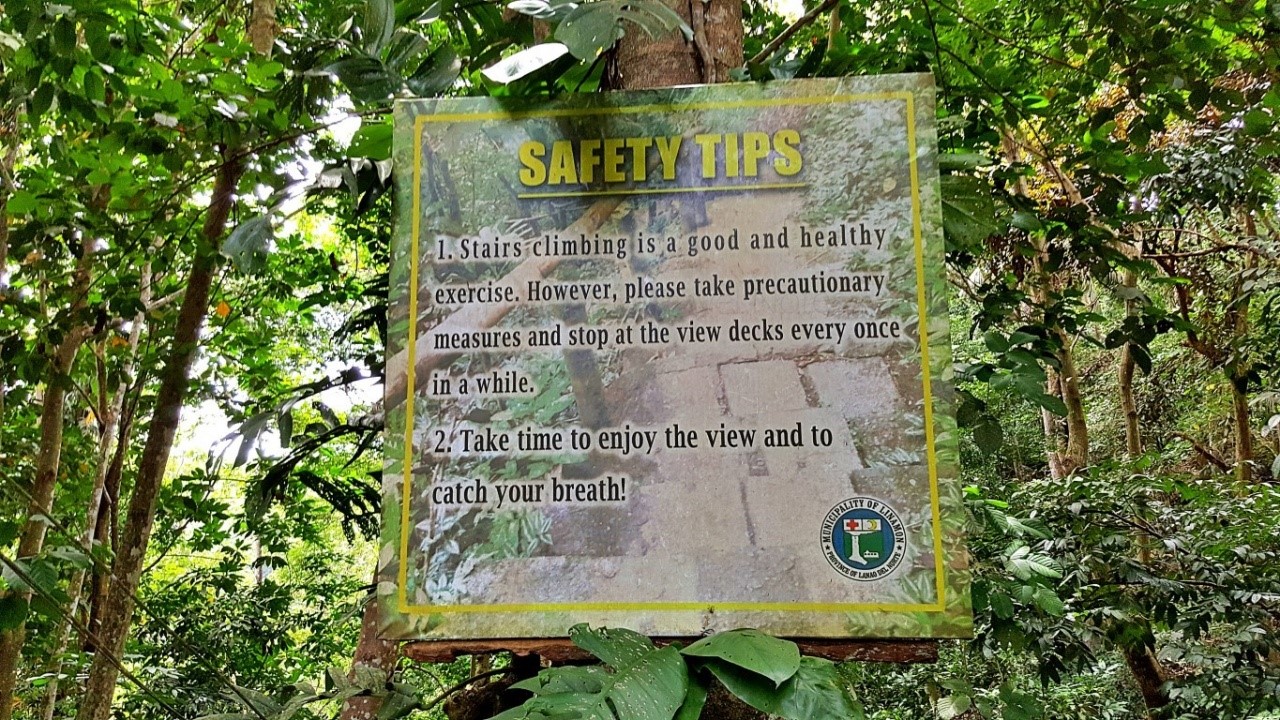 safety tips printed on a billboard along the stairs going down to Tinago Falls