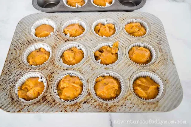 pumpkin muffin batter in muffin pan