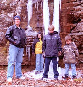 Dylan, Daniel, James, and Jacob standing in front of a frozen waterfall
