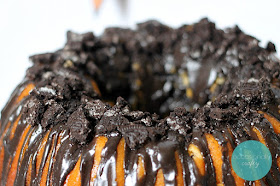 Delicious pound cake recipe made with orange soda and drizzled with chocolate-orange icing, topped with OREO crumbles.  This dessert is perfect for Halloween or for any occasion!