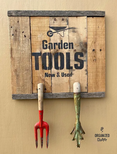 Photo of a pallet sign stenciled with a garden tools stencil