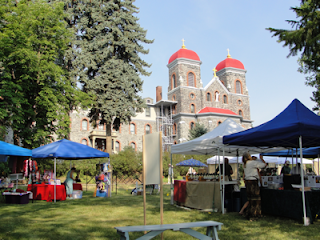 A picture of a Benedictine Monastery with tents and people