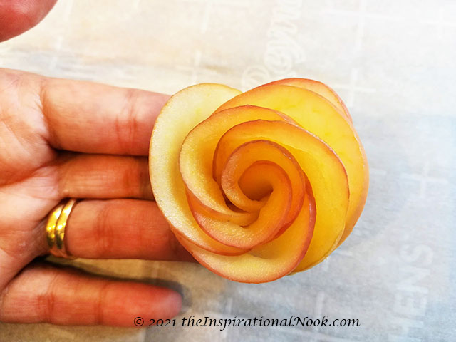 Apple roses, fruit flower, flower garnish, lady's hand holding apple rose