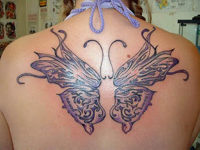 This beautiful butterfly tattoo design on the back of this woman.