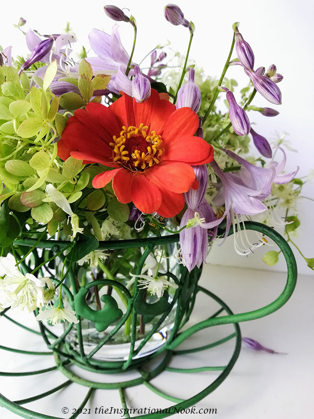 Teacup wire planter, garden decor, wire teacup and saucer, whimsical flower arrangment, unique flower vase arrangment, unique flower ideas (10), whimsical flower arrangment, orange, purple and green floral color scheme, fresh floral arrangements, fresh flower centerpieces, fresh arrangement, real flower arrangements, Autumn flower arrangement, fall flower arrangement, orange zinnias, limelight hydrangea, purple hostas, autumn clematis