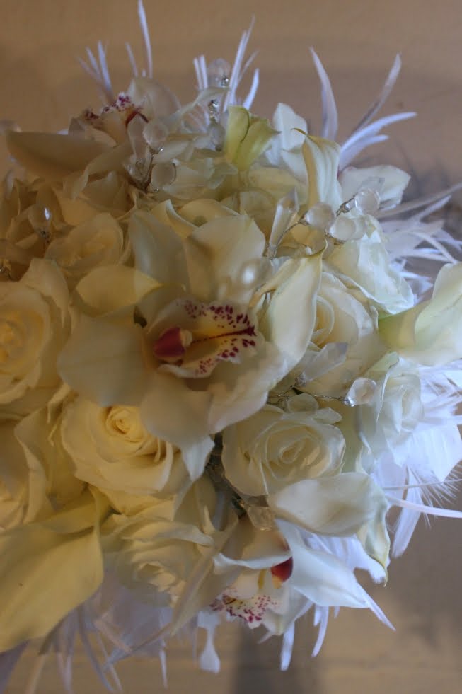 The bouquet with white feathers also has small crystals within the flowers