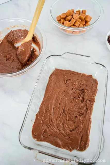 half of the chocolatey brownie batter in a glass pan