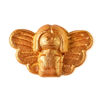 An angel shaped bubble bar with wings coated in gold glitter overlay on a bright background