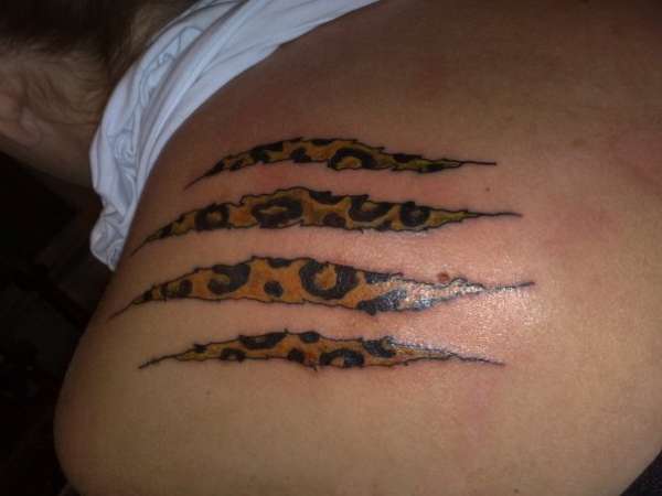 leopard tattoos. While her leopard print top and gold chain look quite chic,