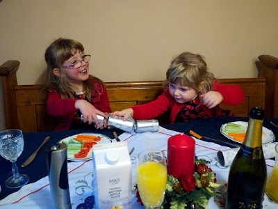 Jessica and Sophie pulling a cracker over Christmas dinner