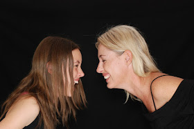 Mom and daughter facing each other, laughing, tongue twister challenge