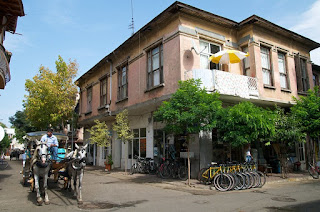 A street, with a house, a cart, and bicycles in Buyukada.