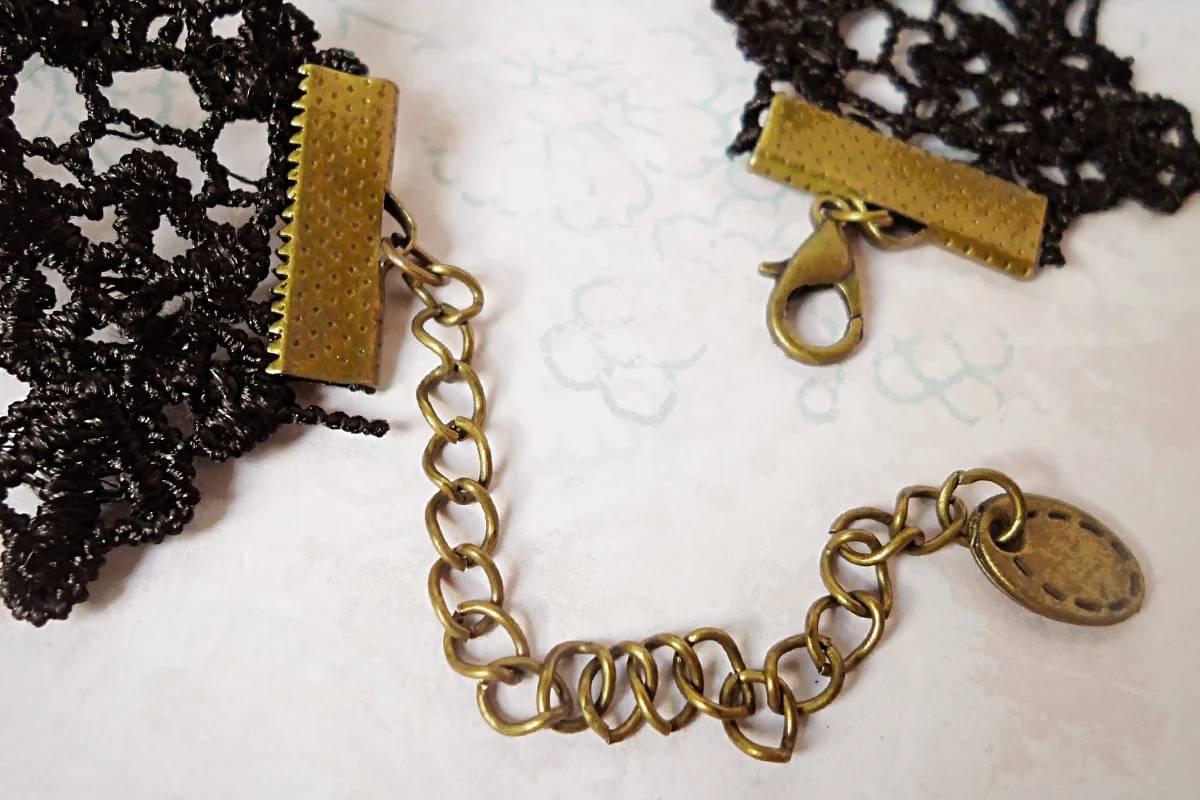 a very beautiful, gothic lace chocker with a cameo pendant on a patterned light background