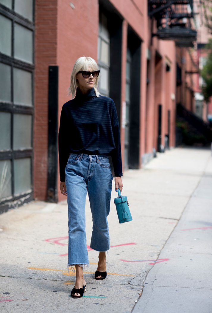 How to Wear Mule Sandals for Fall — Linda Tol Street Style Outfit With Cat-Eye Sunglasses, Raw-Hem Jeans, and Mini Bag