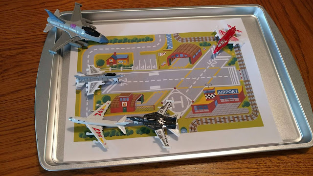 Printed airport scene with toy airplanes