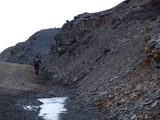 Matt Stimson walking along the road cut on the Sussex highway